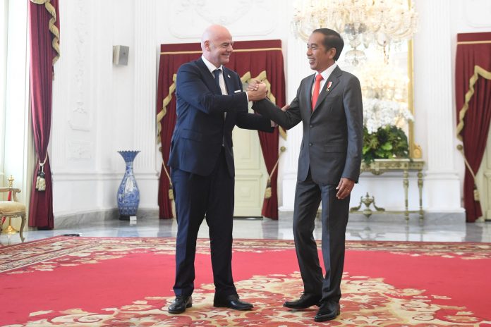 Indonesian President Joko Widodo shakes hands with FIFA’s president Gianni Infantino during their meeting at the Merdeka Palace in Jakarta